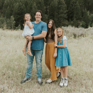 Dr. Andrew Chappell with his family in a scenic field in West Jordan.