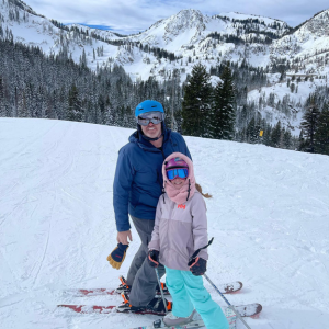 Dr. Andrew Chappell skiing with his child in the mountains near West Jordan.