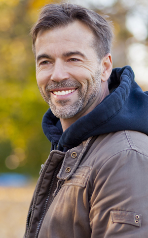 A man showing his dental crowns