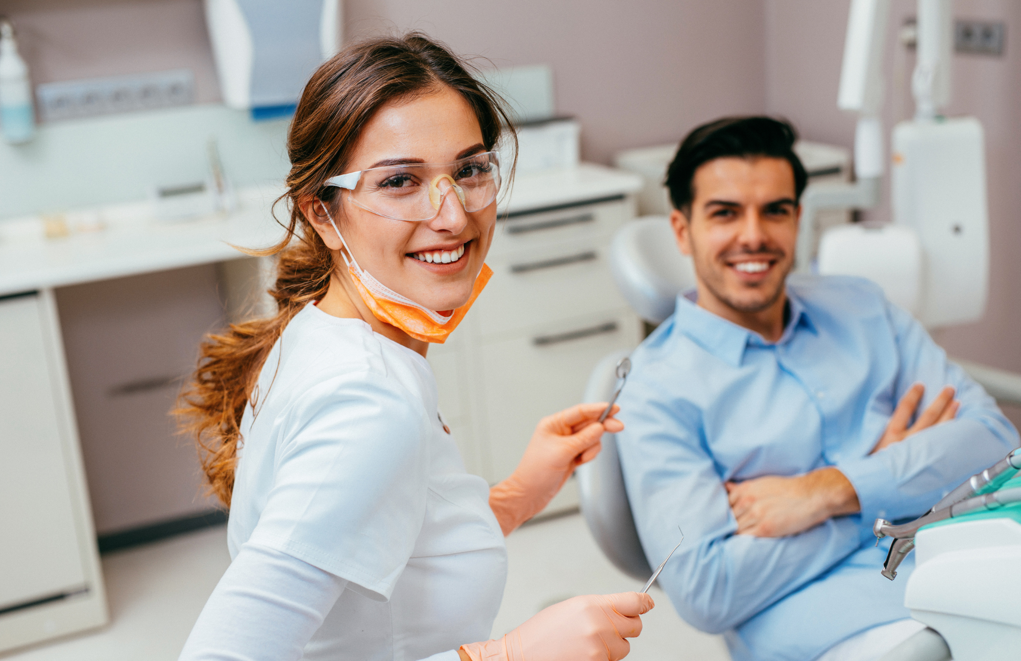 happy male patient inside the clinic with the dentist